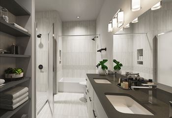 a bathroom with a sink and a shower in a 555 waverly unit